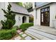 Home's exterior features a walkway and lush landscaping at 805 Pinehurst Dr, Chapel Hill, NC 27517