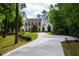 House exterior with a long driveway and lush landscaping at 805 Pinehurst Dr, Chapel Hill, NC 27517