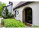 Inviting front entrance with arched doorway and landscaping at 805 Pinehurst Dr, Chapel Hill, NC 27517