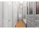 Long hallway with built-in storage and hardwood floors at 805 Pinehurst Dr, Chapel Hill, NC 27517