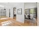 Hallway with hardwood floors offering views of dining room and other rooms at 805 Pinehurst Dr, Chapel Hill, NC 27517