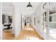 Bright hallway with hardwood floors and access to multiple rooms at 805 Pinehurst Dr, Chapel Hill, NC 27517