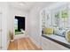 Bright hallway with built-in window seat and view into a game room at 805 Pinehurst Dr, Chapel Hill, NC 27517