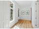 Hallway with white wainscoting, hardwood floors, and a view of the pool at 805 Pinehurst Dr, Chapel Hill, NC 27517