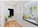 Light-filled hallway with built-in window seat and access to backyard at 805 Pinehurst Dr, Chapel Hill, NC 27517