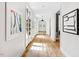 Light-filled hallway with hardwood floors and artwork at 805 Pinehurst Dr, Chapel Hill, NC 27517