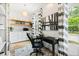 Home office with built-in shelves, desk, and hardwood floors at 805 Pinehurst Dr, Chapel Hill, NC 27517