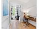 Home office with wood desk, comfortable chair, and access to a sunroom at 805 Pinehurst Dr, Chapel Hill, NC 27517