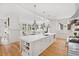 Bright white kitchen features a large island, stainless steel appliances, and hardwood floors at 805 Pinehurst Dr, Chapel Hill, NC 27517