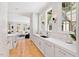White kitchen with quartz countertops and stainless steel appliances at 805 Pinehurst Dr, Chapel Hill, NC 27517