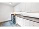 Clean laundry room with white cabinets and dark countertop at 805 Pinehurst Dr, Chapel Hill, NC 27517