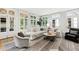 Light-filled living room with ample seating, a large sectional sofa, and multiple windows at 805 Pinehurst Dr, Chapel Hill, NC 27517