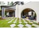 Outdoor patio with multiple seating areas, checkerboard grass, and archways at 805 Pinehurst Dr, Chapel Hill, NC 27517