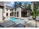 Luxury lap pool with spa, surrounded by a stone patio and comfortable loungers at 805 Pinehurst Dr, Chapel Hill, NC 27517
