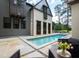 Luxury pool with patio furniture and landscaping, adjacent to home at 805 Pinehurst Dr, Chapel Hill, NC 27517