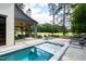 Relaxing pool and spa with patio and loungers, overlooking a golf course at 805 Pinehurst Dr, Chapel Hill, NC 27517