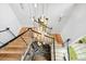 Elegant staircase with modern metal railings and a stunning light fixture at 805 Pinehurst Dr, Chapel Hill, NC 27517