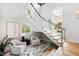 Modern staircase with cable railing and seating area at 805 Pinehurst Dr, Chapel Hill, NC 27517
