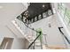 Modern staircase with metal railings and high ceilings at 805 Pinehurst Dr, Chapel Hill, NC 27517