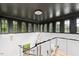 Modern staircase with dark ceiling, multiple windows, and light fixture at 805 Pinehurst Dr, Chapel Hill, NC 27517