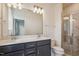 Bathroom features a double vanity, large mirror and a shower at 833 Parc Townes Dr # 17, Wendell, NC 27591