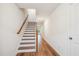 Modern staircase with wooden handrail and light flooring at 833 Parc Townes Dr # 17, Wendell, NC 27591