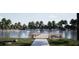 Scenic view of the lake with a fishing dock and beautiful, mature trees lining the shoreline at Tbd Charlotte Knoll St # 13, Zebulon, NC 27597