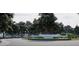 Community entrance featuring a beautiful stone monument surrounded by lush landscaping and mature trees at Tbd Charlotte Knoll St # 13, Zebulon, NC 27597