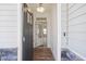 Open entryway with dark gray front door and wood floors at Tbd Charlotte Knoll St # 13, Zebulon, NC 27597