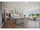 Spacious kitchen with gray cabinets, large island, pendant lighting, and a dining area at Tbd Charlotte Knoll St # 13, Zebulon, NC 27597