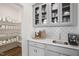 Butler's pantry features elegant gray cabinets, white countertops, backsplash, and convenient shelving at Tbd Charlotte Knoll St # 13, Zebulon, NC 27597