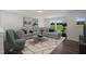 Cozy living room with plush gray sectional and neutral decor at Tbd Charlotte Knoll St # 13, Zebulon, NC 27597