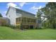 Large backyard showcasing a spacious covered porch, and lush green lawn at 125 Charlotte Knoll St # 15, Zebulon, NC 27597