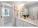 Bright bathroom featuring double sinks with white cabinets, quartz countertops, and framed mirrors at 125 Charlotte Knoll St # 15, Zebulon, NC 27597