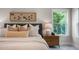 A close up showcases the bed, the stylish decor and bright window at 125 Charlotte Knoll St # 15, Zebulon, NC 27597