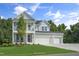Beautiful two-story house boasting a double-decker porch, a lush lawn, and a large three-car garage at 125 Charlotte Knoll St # 15, Zebulon, NC 27597
