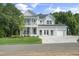 Stunning two-story home featuring a double-decker porch, well-manicured lawn, and a spacious three car garage at 125 Charlotte Knoll St # 15, Zebulon, NC 27597