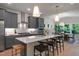 Modern kitchen with gray cabinets, a large island, and stainless steel appliances with an adjacent dining area at 125 Charlotte Knoll St # 15, Zebulon, NC 27597