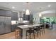 Contemporary kitchen features stainless steel appliances, a large island with seating, and gray cabinetry at 125 Charlotte Knoll St # 15, Zebulon, NC 27597