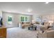 Spacious living room featuring plush seating, natural light, and neutral color palette at 125 Charlotte Knoll St # 15, Zebulon, NC 27597