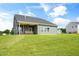 The backyard features a well-manicured lawn, a covered patio with a ceiling fan, and lush landscaping at 116 Charlotte Knoll St # 7, Zebulon, NC 27597
