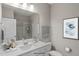 Modern bathroom featuring a single sink vanity, lots of natural light, and a walk-in shower at 116 Charlotte Knoll St # 7, Zebulon, NC 27597