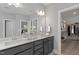 Double vanity bathroom with walk-in closet and grey cabinets at Tbd Charlotte Knoll St # 7, Zebulon, NC 27597