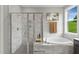 Bright bathroom with a glass shower, a soaking tub, and serene natural light at Tbd Charlotte Knoll St # 7, Zebulon, NC 27597