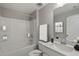 Bright bathroom features a shower and tub combination with a modern vanity and neutral decor at 116 Charlotte Knoll St # 7, Zebulon, NC 27597