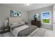 Comfortable bedroom with large window and art at 116 Charlotte Knoll St # 7, Zebulon, NC 27597