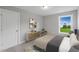 Bedroom with modern furniture, neutral walls, window with outdoor view, and a patterned rug at 116 Charlotte Knoll St # 7, Zebulon, NC 27597