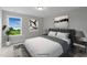 Cozy bedroom featuring neutral paint, plush carpet, and a scenic view at 116 Charlotte Knoll St # 7, Zebulon, NC 27597