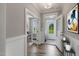 Entryway with an open office area, white trim, wood floors, and natural light from the front door at 116 Charlotte Knoll St # 7, Zebulon, NC 27597