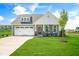 Charming home with a well-manicured lawn, attached two-car garage, covered front porch, and inviting curb appeal at 116 Charlotte Knoll St # 7, Zebulon, NC 27597